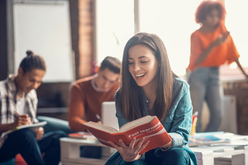 Beaming student feeling happy while studying foreign language