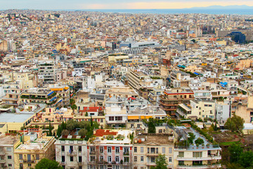 Fototapeta na wymiar Panoramic view of Athens from Acropolis Hill in sunny winter day. Colorful residential buildings. Urban landscape. Athens, Greece