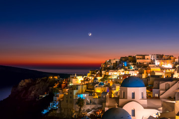 Late Evening and the Moon Over the Rooftops of Oia on the Island of Thira