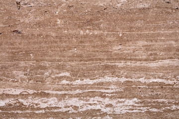 Natural hard travertine background in brown color as part of your design work. High quality texture.