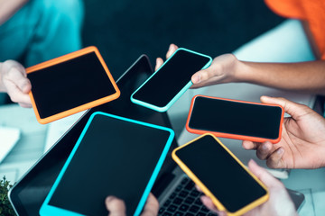 Students holding gadgets while using them during break