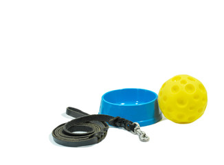 Pet accessories concept.  Leather leash and bowl with toy on isolated white