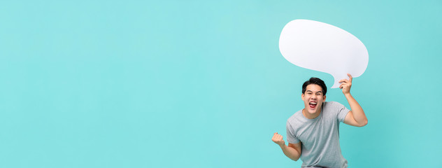 Excited Asian man with speech bubble on banner light blue background