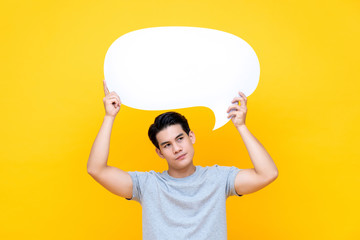 Unhappy bored young Asian man with empty speech bubble