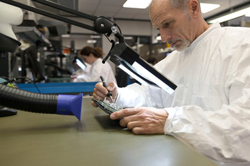 Engineer working in lab on microeletronics system