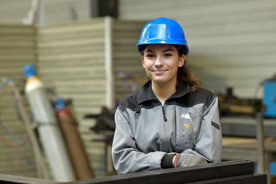 Portrait of steelworks apprentice with security helmet