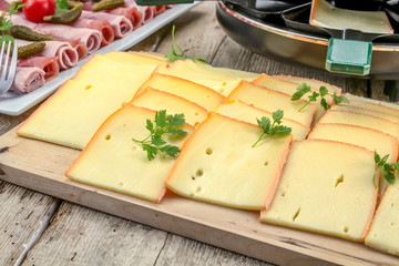 fromage à raclette et charcuterie sur une table