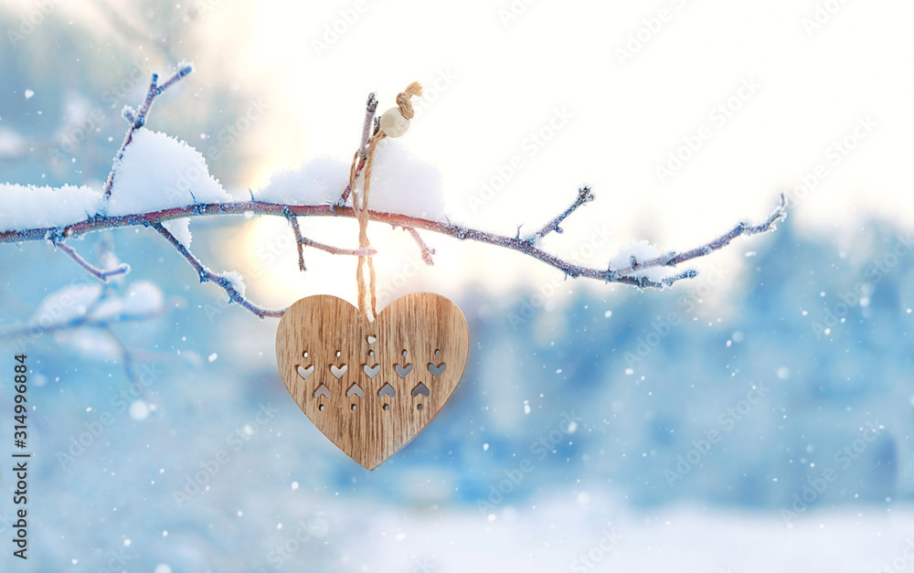 Wall mural valentine's day concept. scandinavian wooden heart in snowy winter garden. minimal hygge, scandi sty