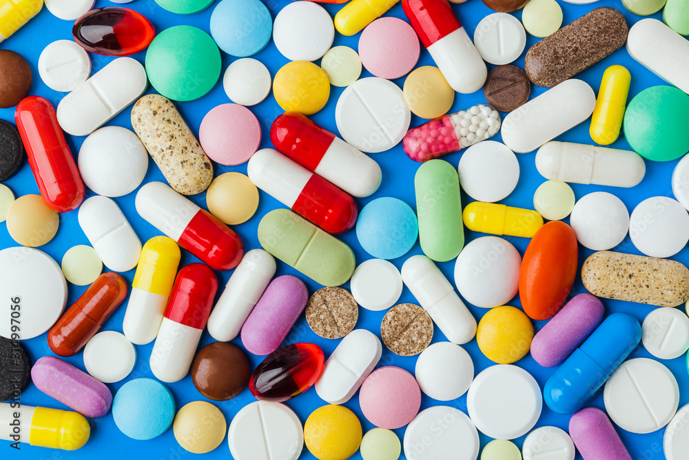 Wall mural Heap of pills - medical background