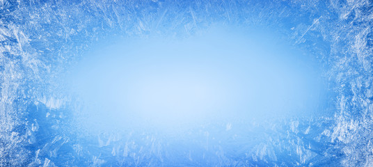 Frost patterns on frozen window as a symbol of Christmas wonder. Christmas or New year background.