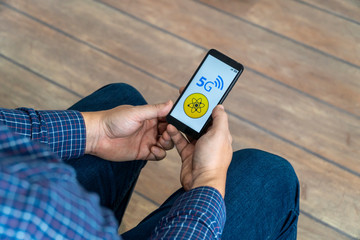 Person looking at a 5g danger message on his phone
