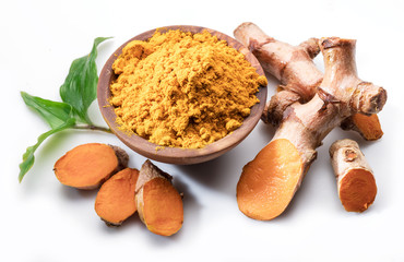 Fresh turmeric rhizome and turmeric powder isolated on white background.