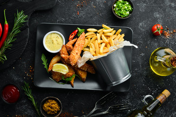 Chicken nuggets, french fries and sauce. Top view. Free space for your text.