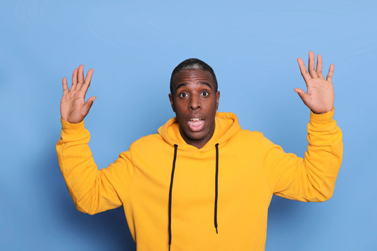 The Young Attractive Man Looking Suprised Isolated On Blue Background