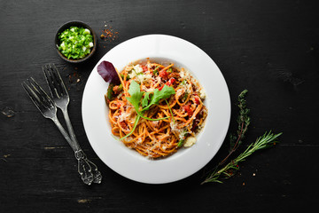 Pasta with tomatoes and vegetables. Carbonara. Italian cuisine. Top view. Free space for your text.