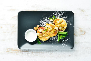 Cheese pancakes with sour cream. Dessert. Top view. Free space for your text.