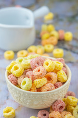 Cereal flakes in white bowl with copy space,Breakfast concept.Food with delicious fruity taste and fruity colours.It's made with maize,wheat,and barley