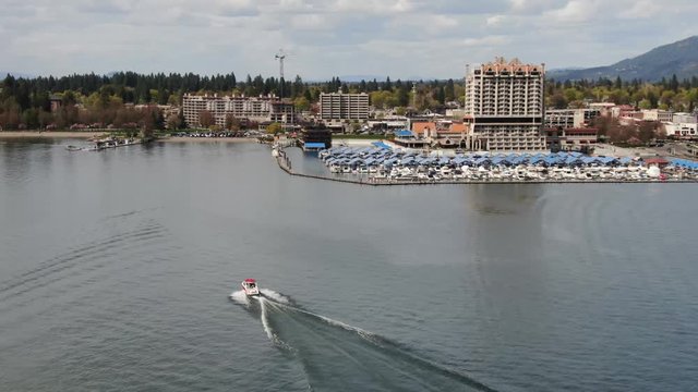An aerial video of a sport boat as it approaches the Coeur d'Alene Resort Marina on Lake Coeur d'Alene.