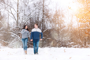 Fototapeta na wymiar wedding engagement Concept. people, season love and leisure concept. happy couple walking through the park on a snowy day. Romantic couple in love feeling happiness romance Valentine . love copy space