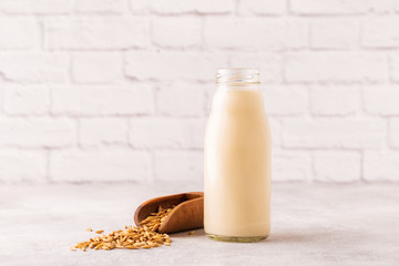 A bottle of oat milk and oats.