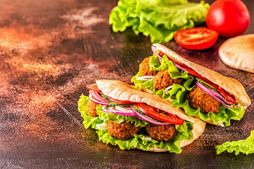 Falafel and fresh vegetables in pita bread.