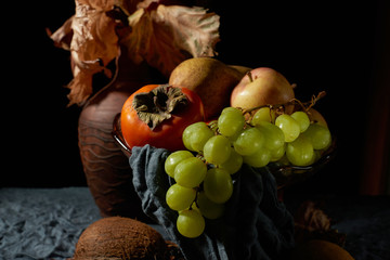 Naklejka na ściany i meble Basket of ripe fruits on the table.