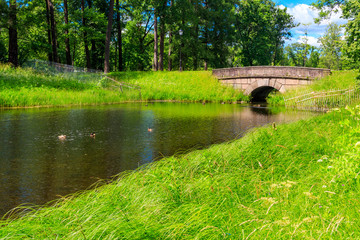 Stone arch bridge across a small river in Catherine park in Pushkin (Tsarskoye Selo), Russia