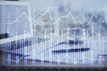 Forex graph hologram on table with computer background. Double exposure. Concept of financial markets.
