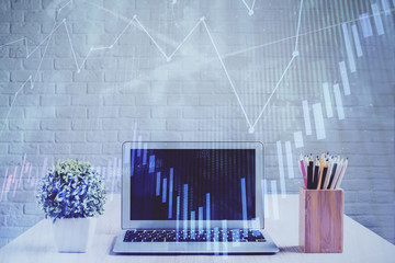 Financial graph colorful drawing and table with computer on background. Double exposure. Concept of international markets.