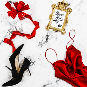 Gift box red dress black high heels Shopping fashion flat lay
