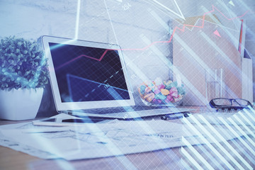 Forex market graph hologram and personal computer on background. Double exposure. Concept of investment.