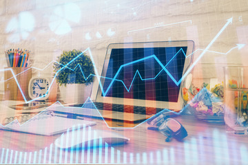Financial graph colorful drawing and table with computer on background. Double exposure. Concept of international markets.