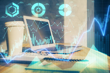 Stock market chart hologram drawn on personal computer background. Multi exposure. Concept of investment.