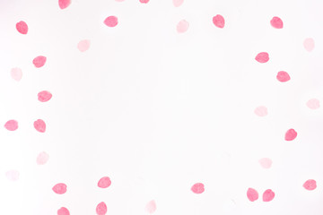 Valentine's day background with scattered paper pink rose petals on a white background