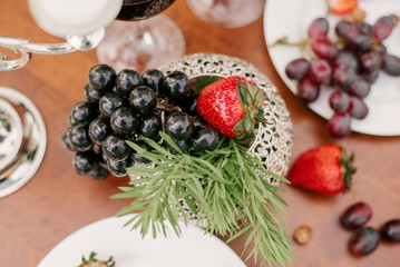 Fresh fruit, grapes and strawberries in the table setting or decoration