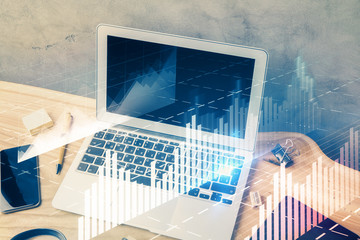 Double exposure of graph and financial info and work space with computer background. Concept of...