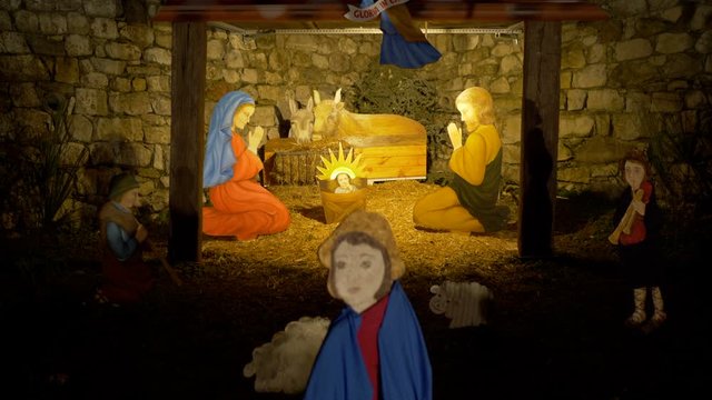 Nativity scene with hand-colored figures made out of wood including Jesus, Mary, Joseph and sheep