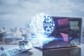 Double exposure of blockchain theme hologram and table with computer background. Concept of bitcoin crypto currency.