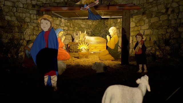 Nativity scene with hand-colored figures made out of wood including Jesus, Mary, Joseph and sheep