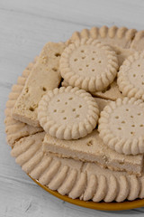 Shortbread biscuits cookies on brown plate. Grey wood background