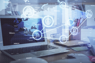 Computer on desktop with social network theme icon. Multi exposure. Concept of international connections.