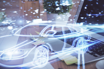 Desktop computer background in office with automobile hologram drawing. Multi exposure. Tech concept.