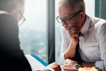 Corporate business team meeting discussion and startup concept. Successful businesspeople discussing together in conference room during meeting at modern business lounge high up in an office tower.