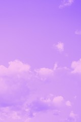 Pale violet background. Beautiful fluffy clouds on a sky background. Copy space. Purple violet toned