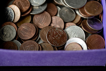 Purple box with American cents close-up. Money background