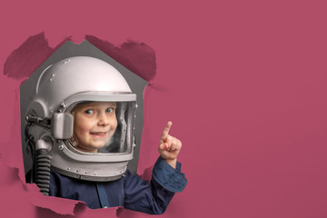 Small child wants to fly an airplane wearing an airplane helmet