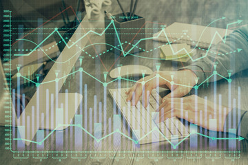 Double exposure of financial graph with man works in office on background. Concept of analysis.