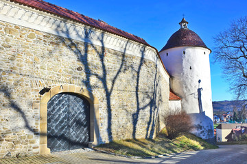 Gate in stone wall and medieval tower.  Monastery of the Poor Clares, Stary Sacz, Poland, 13th...