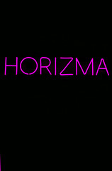 Glowing neon sign on isolated black background. Horizma neon sign. Charisma. Neon concept. Trendy style. 