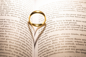 Golden wedding ring on bible book